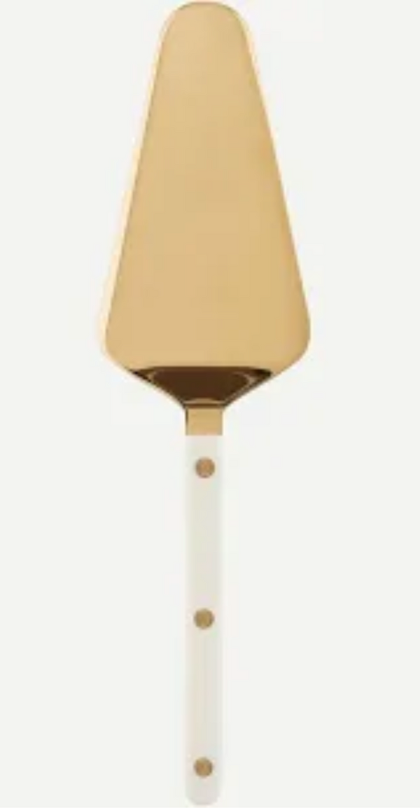 The Sabre Bistro Pearly Gold Tart Server features a gold metal triangular blade and a white acrylic handle with three gold rivets, from the elegant Bistrot collection, shown on a light background.