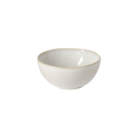 The Brisa Branca Dinnerware bowl by Casafina/Costa Nova is a small, round, off-white stoneware piece with a subtly wavy rim, handcrafted in Portugal and pictured on a plain white background.