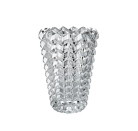 The Zig Zag Vase by Baccarat features a geometric, honeycomb-like textured crystal surface, reminiscent of contemporary sculpture, displayed against a plain white background.