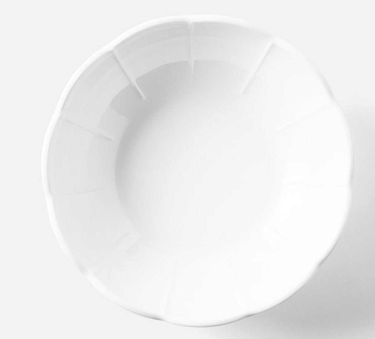 A top-down view of an empty, white, scalloped-edge bowl from the Iris Melamine Dinnerware Set of 4 by Blue Pheasant, placed against a plain white background.