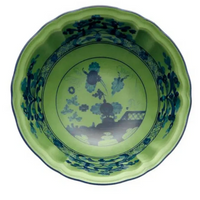Ginori 1735's Oriente Italiano Dinnerware Malachite bowl features intricate blue floral and landscape motifs inside a green scalloped form, showcasing the refined elegance of Italian craftsmanship.