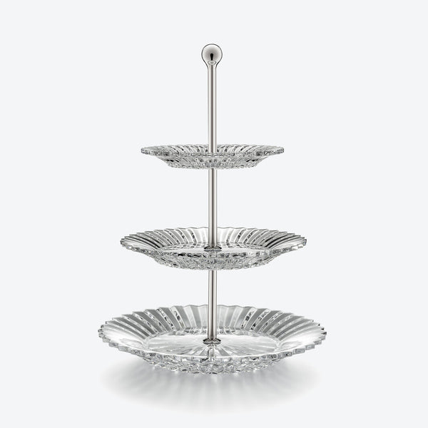 The Mille Nuit Pastry Stand by Baccarat is a three-tiered stand with decorative crystal scalloped plates on a central metal rod, displayed against a plain white background.