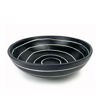 The Michael Wainwright Linea Bowl Black is a round, black ceramic bowl featuring white concentric circle patterns inside, displayed on a plain white background.