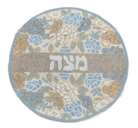 Add elegance to your Passover table with the Lyss & Kat Hebrew Floral Beaded Matzah Cover - Pastel, featuring round hand-beading, pastel blue, gold, and white floral accents, plus מצה (matzah) in Hebrew at the center.