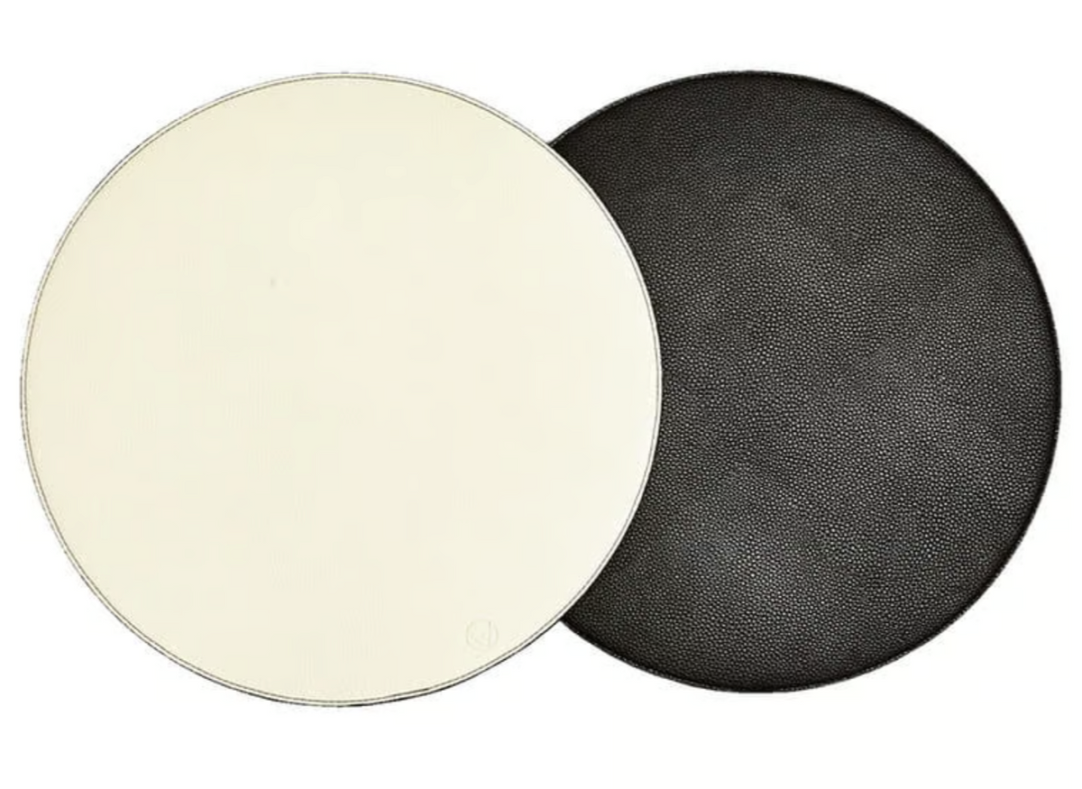 A round white mat overlays a textured black one—both reversible placemats by Von Gern Home, set of 4—perfect for an elegant table setting.