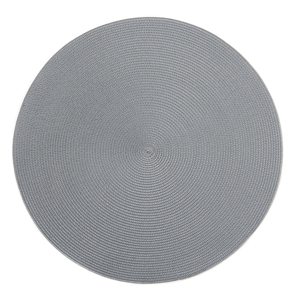 The Linen Braid 15" Placemat Set of 4 by Deborah Rhodes features round, light gray woven nylon placemats with a braided texture, adding style and durability to any table setting. Shown from above against a white background.