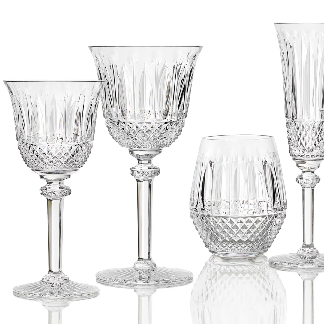 The Saint-Louis Tommy Stemware set includes four crystal glasses: two wine glasses, a tumbler, and a flute, each crafted with diamond-cut patterns and ornate detailing.