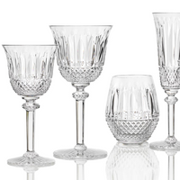 The Saint-Louis Tommy Stemware set includes four crystal glasses: two wine glasses, a tumbler, and a flute, each crafted with diamond-cut patterns and ornate detailing.