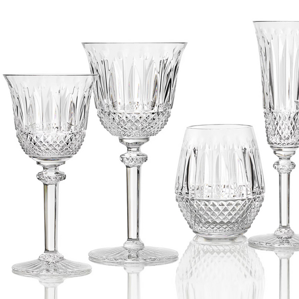 The Saint-Louis Tommy Stemware set includes four crystal glasses: two wine glasses, a tumbler, and a flute, each crafted with diamond-cut patterns and ornate detailing.