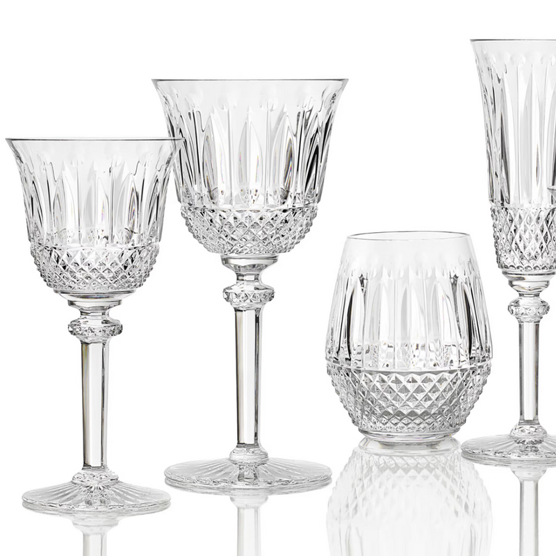 The Saint-Louis Tommy Stemware set includes four crystal glasses: two wine glasses, a tumbler, and a flute, each crafted with diamond-cut patterns and ornate detailing.