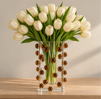 A bouquet of white tulips in a clear square Tizo Scattered Balls Vase Brown decorated with small brown spheres.