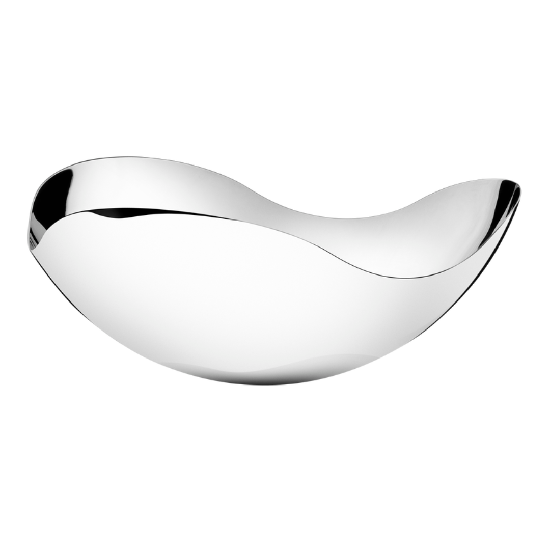 The Georg Jensen Bloom Serving Bowl features an asymmetrically curved silhouette and a mirror-polished stainless steel finish, creating a striking modern centerpiece against a white background.