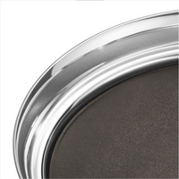 A close-up of the Georg Jensen Manhattan Tray With Leather Liner, featuring a shiny silver metal rim and textured dark gray leather liner, set against a white background.