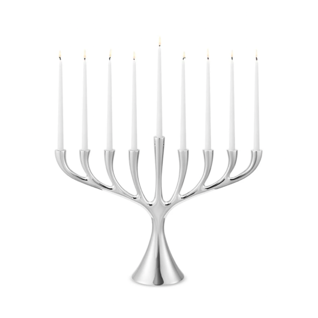 The Georg Jensen Cobra Stainless Steel Menorah displays nine lit white candles in a modern Scandinavian design, set against a plain white background.