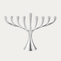 The Georg Jensen Cobra Stainless Steel Menorah features a sleek, branched design reminiscent of Scandinavian style, shown against a light gray background.