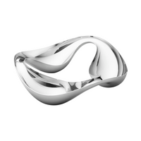 The Georg Jensen Cobra Snack Bowl features a shiny, abstract stainless steel design with smooth curves and an open, sculptural shape—making it a striking centerpiece against a white background.