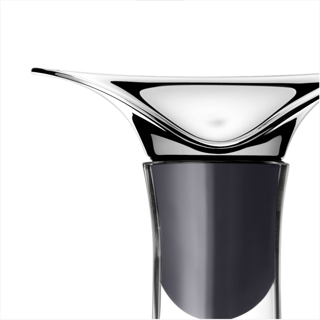 A close-up of the Georg Jensen Wine & Bar Carafe, featuring sleek silver and black curves with a glossy finish, set against a plain white background.