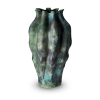 The Cenote Vase Green XLarge by L'Objet is a tall, sculpted porcelain piece with an undulating surface and ruffled rim, finished in reactive dark green, blue, and black glazes for a richly textured organic look.