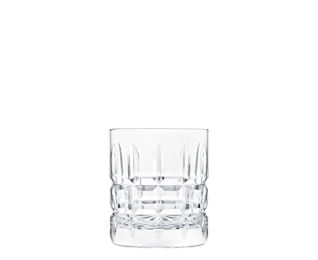 An empty Manhattan Barware crystal tumbler by Saint-Louis, featuring decorative vertical and horizontal cuts, is displayed against a white background.