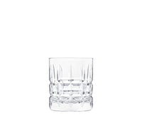 An empty Manhattan Barware crystal tumbler by Saint-Louis, featuring decorative vertical and horizontal cuts, is displayed against a white background.