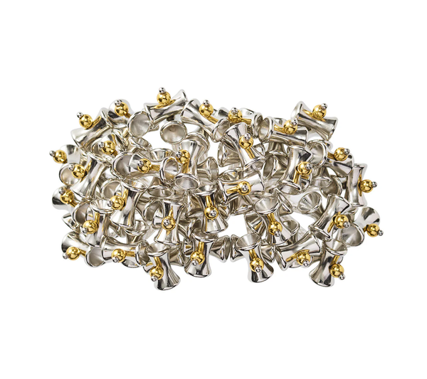 The Lucent Napkin Ring in Silver & Gold by Kim Seybert (Set of 4) features handcrafted charm with small gold accents, adding an elegant touch to contemporary tablescapes.