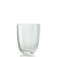 The Idra Tumbler Torse by Nason Moretti is a clear glass tumbler featuring a subtle diagonal ribbed pattern, displayed on a white background with a gentle reflection at its base.