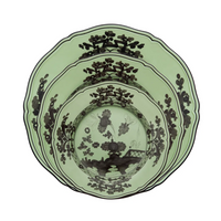 Three green Ginori 1735 Oriente Italiano Dinnerware Bario ceramic plates of varying sizes, each featuring intricate black chinoiserie floral and landscape patterns, are stacked neatly inside one another.
