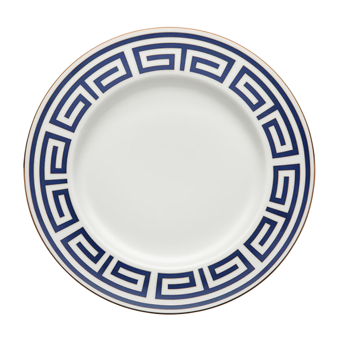 The Ginori 1735 Labirinto Zaffiro Dinnerware features a porcelain plate adorned with a blue Greek key motif and a gold rim.