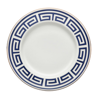 The Ginori 1735 Labirinto Zaffiro Dinnerware features a porcelain plate adorned with a blue Greek key motif and a gold rim.