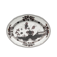 The Oriente Italiano Dinnerware Albus by Ginori 1735 is a white ceramic plate with black and dark brown floral patterns and intricate designs, inspired by Italian porcelain and handcrafted in Italy.