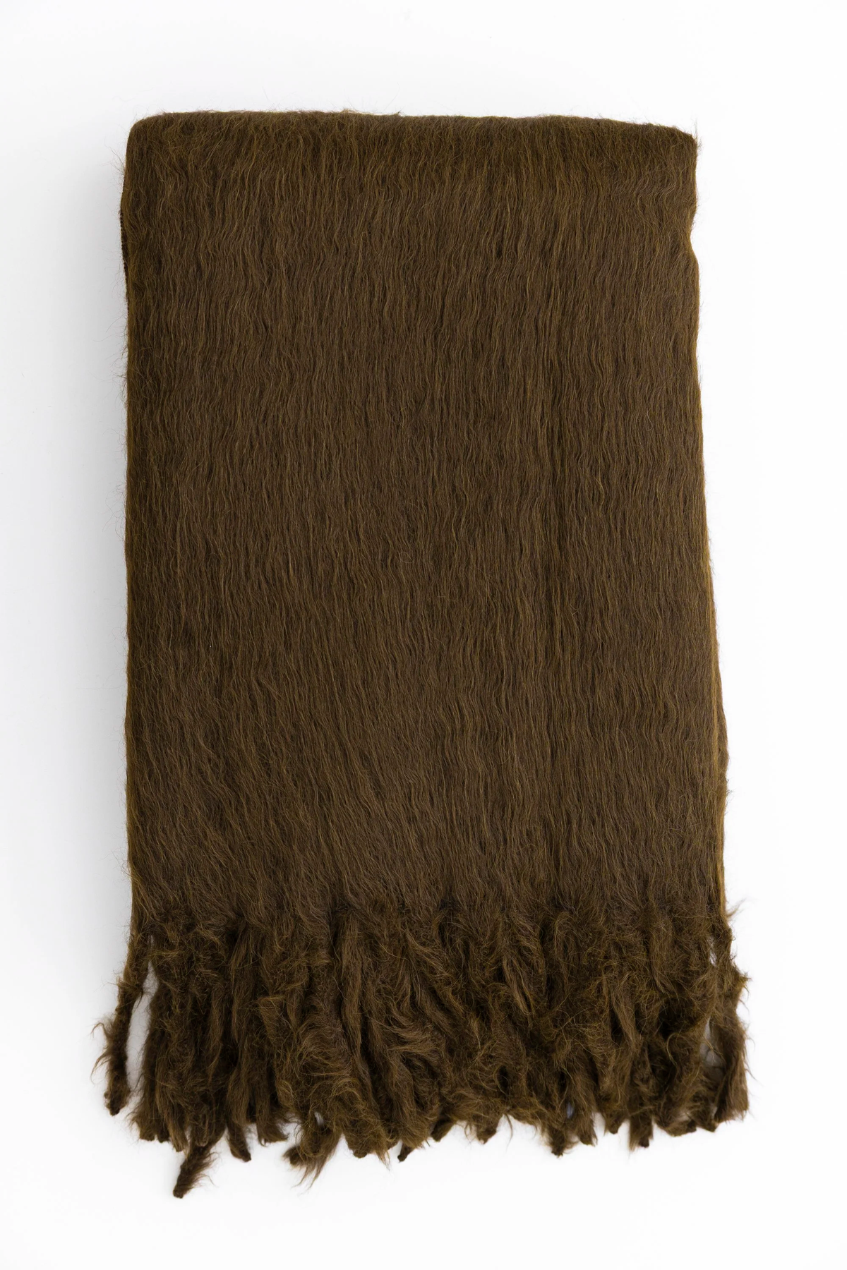 The Woolly Mammoth Throw by Dove & Donkey, a folded brown suri alpaca blanket with a fringed edge, is shown on a white background highlighting its silky soft texture.