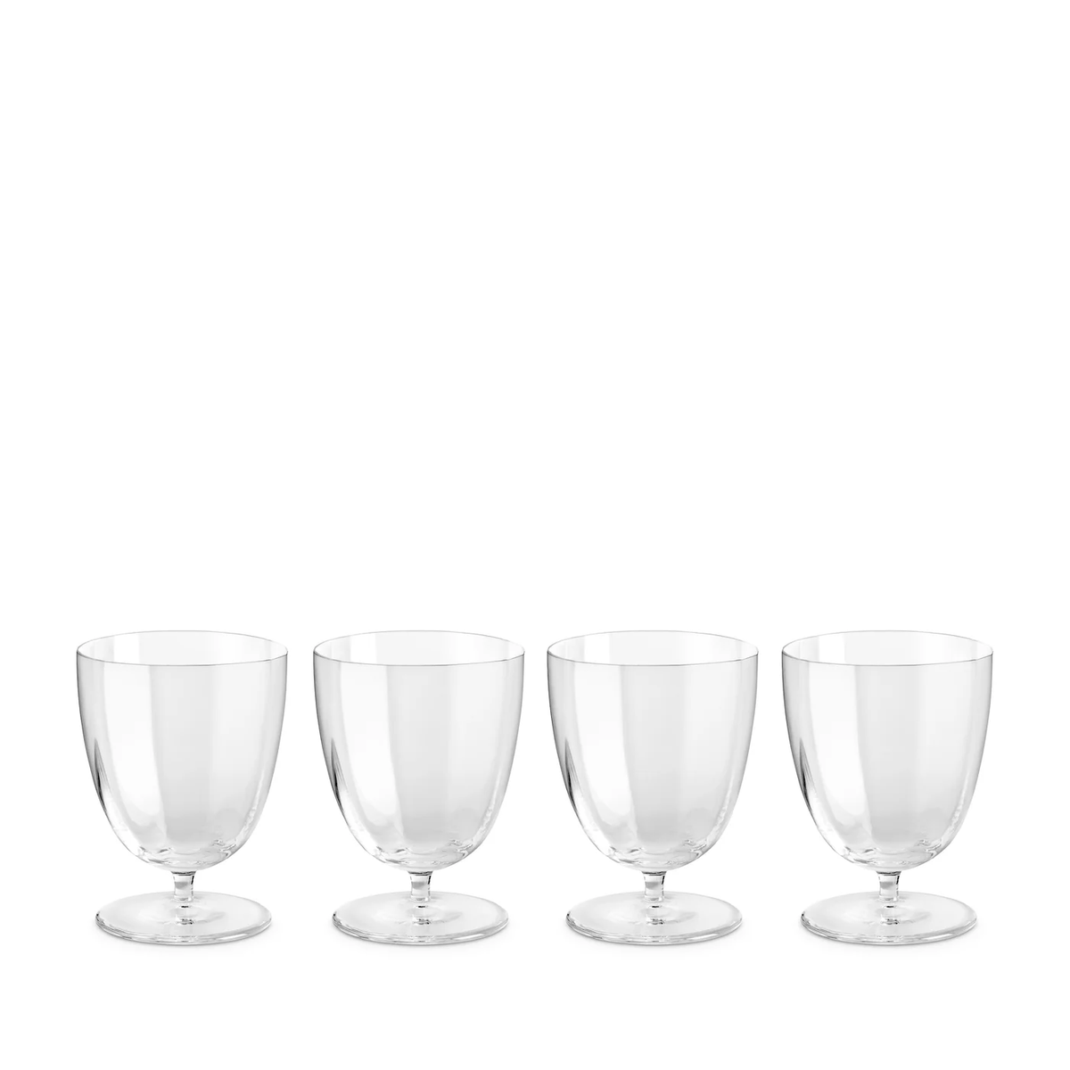 Four Iris Drinkware Collection goblets by L'Objet, made from mouth-blown clear glass with short stems, are arranged in a row on a white background.