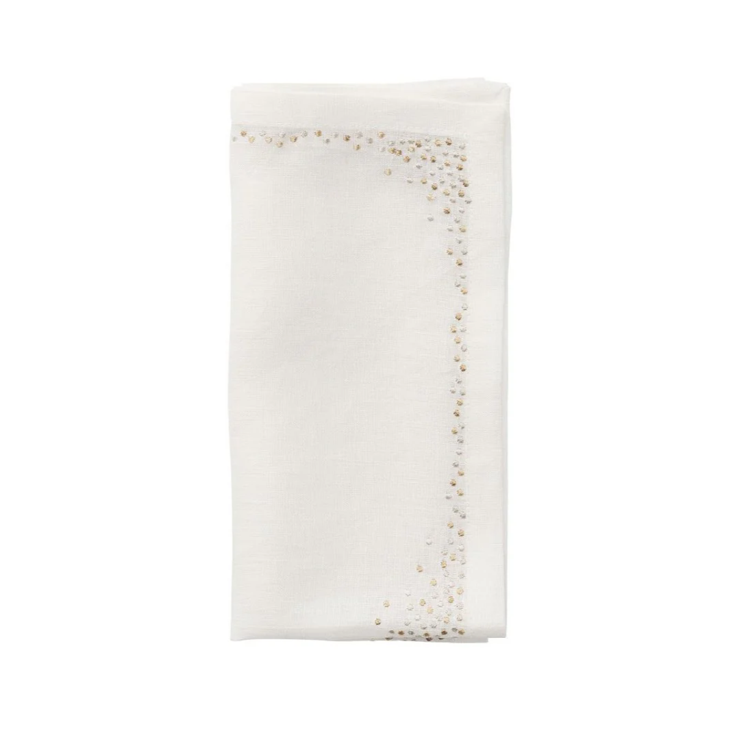 A folded white linen napkin from the Kim Seybert Pin Dot Napkin Set of 4, featuring a subtle beaded design along the border on two adjacent sides, is displayed on a plain white background. This elegant table napkin set brings a refined touch to any dining setting.