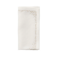 A folded white linen napkin from the Kim Seybert Pin Dot Napkin Set of 4, featuring a subtle beaded design along the border on two adjacent sides, is displayed on a plain white background. This elegant table napkin set brings a refined touch to any dining setting.