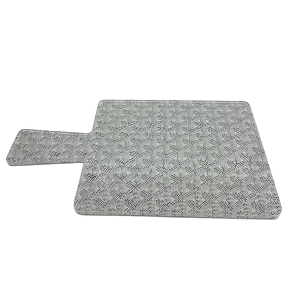 The Eye Candy Maison Charcuterie Board Paddle in grey features a rectangular design with a textured geometric pattern and an extended left side—perfect for serving charcuterie in style.