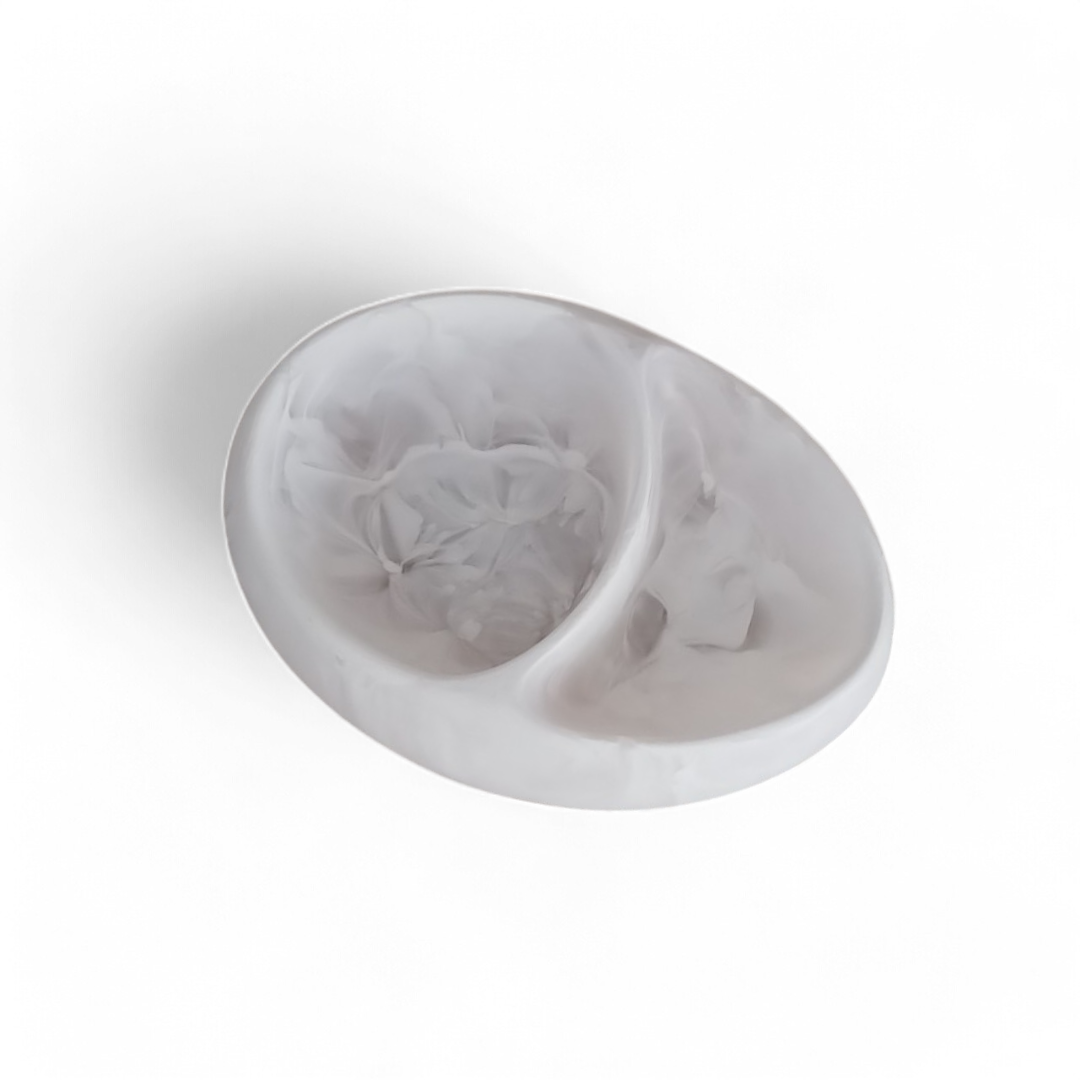 The Arila Split Bowl – White Swirl by Nashi Home is a stylish white, round serving bowl with elegant swirls, perfect for coastal decor and contemporary interiors.