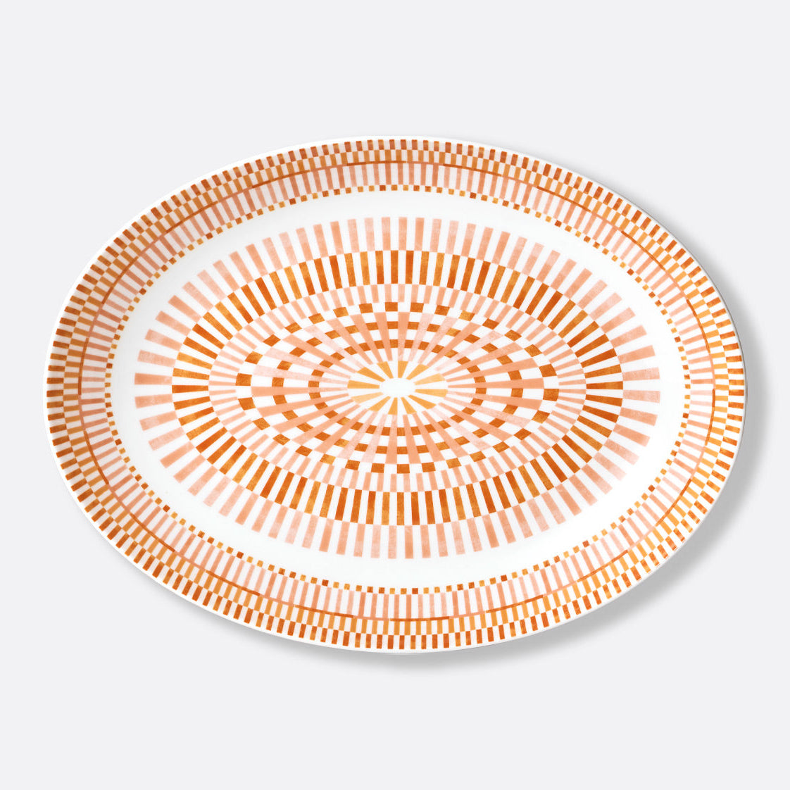 The Bernardaud Terra Rosa Dinnerware is a round white plate adorned with intricate orange and light pink geometric patterns, showcasing elegance and artistry. Made in Limoges, France.