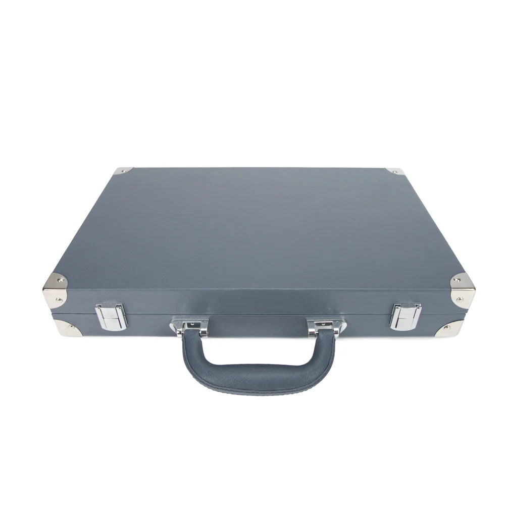 The Brouk & Co Excelsior Backgammon Set is a closed, dark gray briefcase made from vegan leather with silver metal corner protectors, latches, and a sturdy handle, shown against a white background.