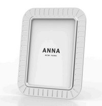 The Striations Frame Silver by Anna New York features vertical and horizontal indented lines and displays “ANNA NEW YORK” at the center, highlighting contemporary elegance and minimalist design.