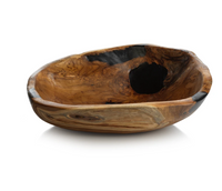 The Zodax Kenya Teakwood Bowl - 20" features an irregular oval shape, rich natural grain, and dark accents. Handcrafted and polished, it brings rustic charm to your home as a unique decorative fruit bowl.