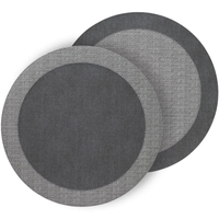 The Bodrum Halo Placemat Set of 4 - Neutrals features round placemats with a woven outer edge and solid center in dark gray, adding modern style to any table setting.