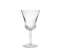The Apollo Stemware by Saint-Louis/Hermes features a fluted bowl, textured stem, and decorative base. This mouthblown, hand-cut crystal wine glass is elegantly displayed on a white background.