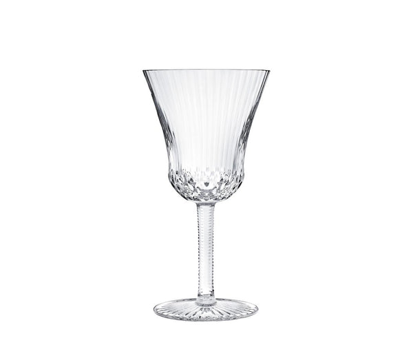 The Apollo Stemware by Saint-Louis/Hermes features a fluted bowl, textured stem, and decorative base. This mouthblown, hand-cut crystal wine glass is elegantly displayed on a white background.