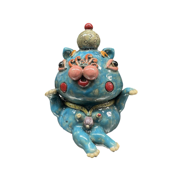 The Threshold Guardian Sculpture by Currey & Company is a whimsical blue handcrafted cat with pink cheeks, large round eyes, a small decorative hat, and quirky details—an artistic decor piece that adds vibrant charm to any space.