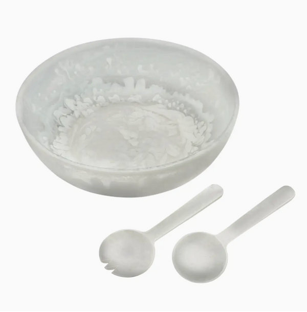 The Eddy Resin Bowl With Servers by Inspired Generations, featuring a stylish bowl paired with matching serving spoon and fork, creates an elegant salad set on a white background—making it a perfect housewarming gift.