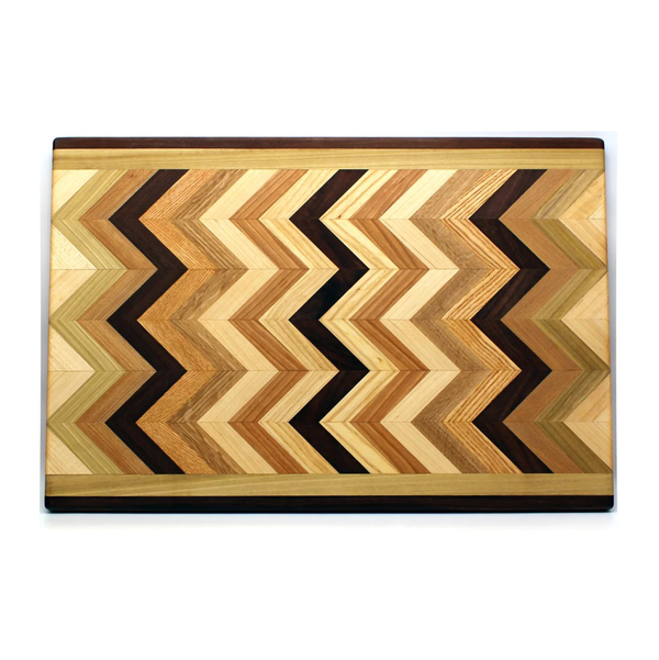 Introducing the Multiwood Herringbone Serving Board from Dickinson Woodworking—a rectangular serving board featuring a striking herringbone pattern crafted from a mix of light, medium, and dark wood tones arranged in an elegant zigzag design.