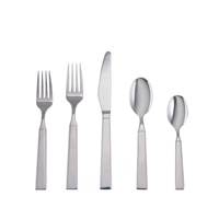 The Simon Pearce Woodstock 5 Piece Setting features two forks, a knife, a soup spoon, and a teaspoon with a modern square-edged design, all arranged side by side on a white background.