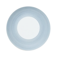 A round, white plate from the JL Coquet Hemisphere Dinnerware Storm Blue collection with a wide, storm blue rim featuring subtle circular lines, viewed from above on a plain white background.