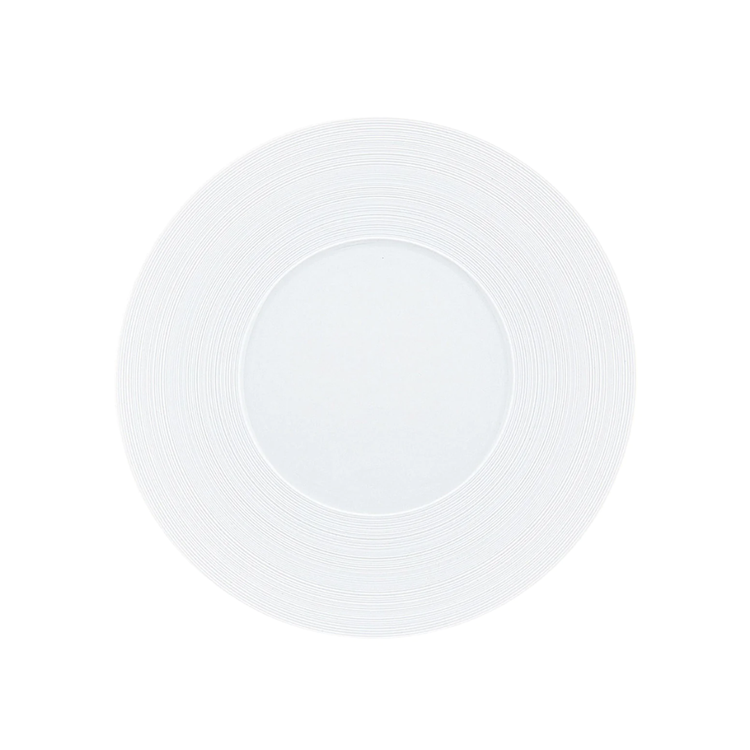 A round ceramic Hemisphere Dinnerware Satin White plate by JL Coquet, featuring a subtle engraved rim, is shown from above on a white background.