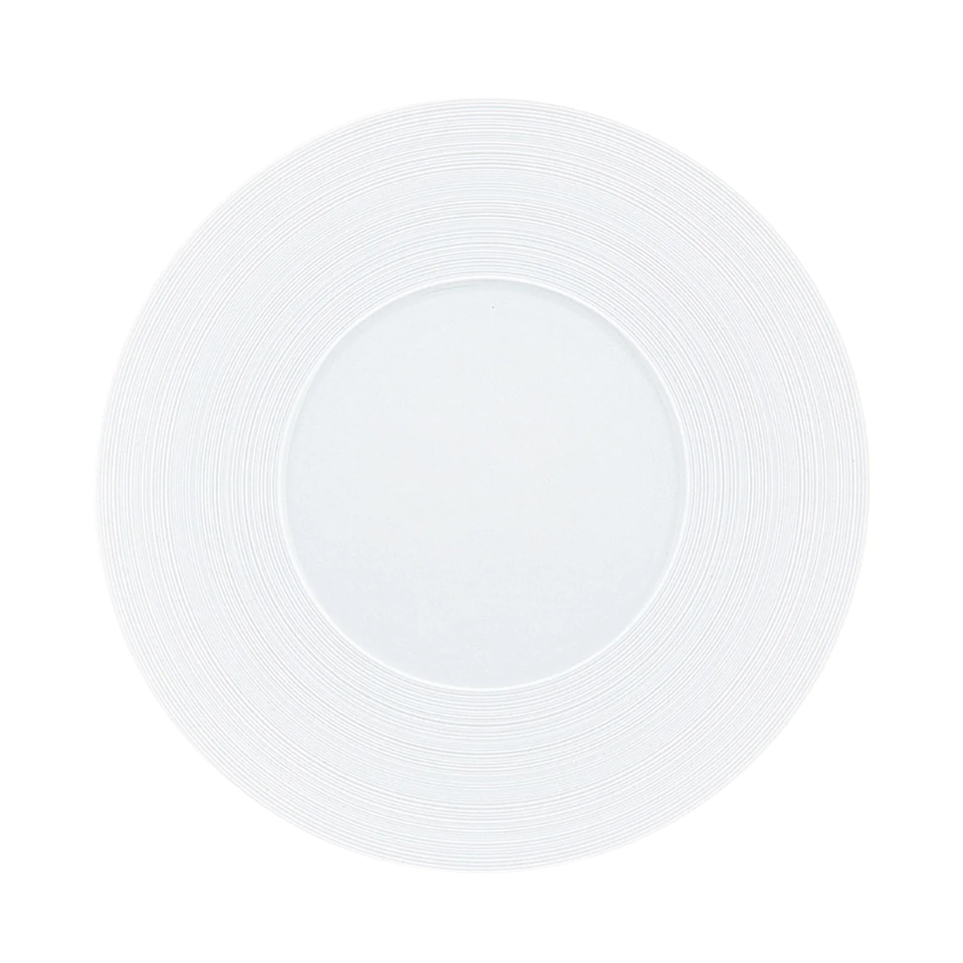 A top-down view of the JL Coquet Hemisphere Dinnerware Satin White plate, featuring a subtle engraved rim pattern, set against a white background.